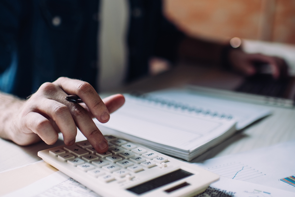 businessman using calculator